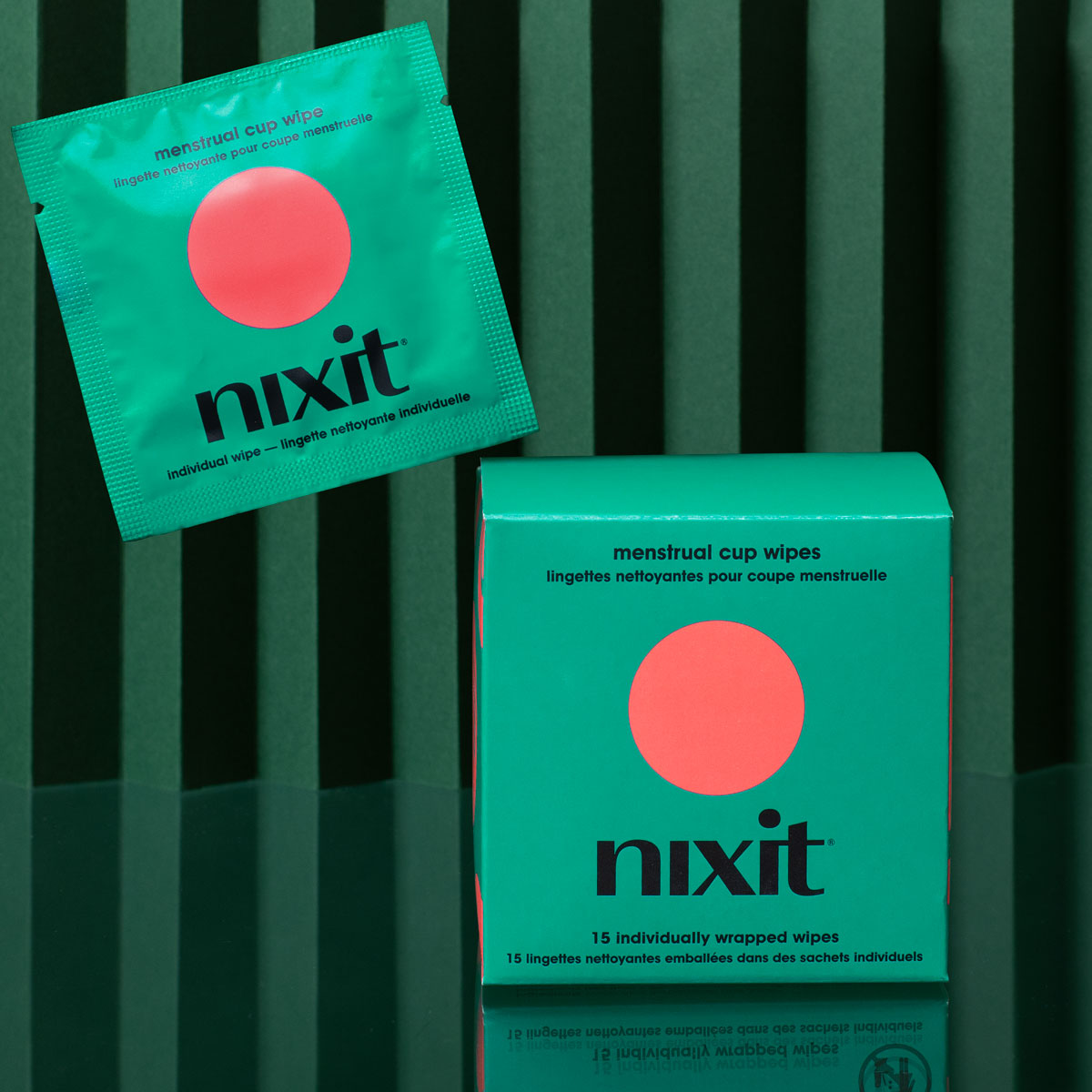 Nixit menstrual cup travel wipes box and individual wipe on green background