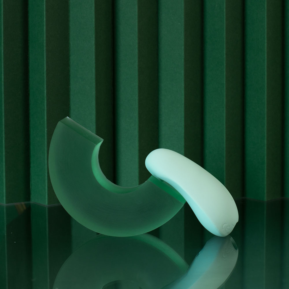 DAME Pom Flexible vibrator in JANE on green background