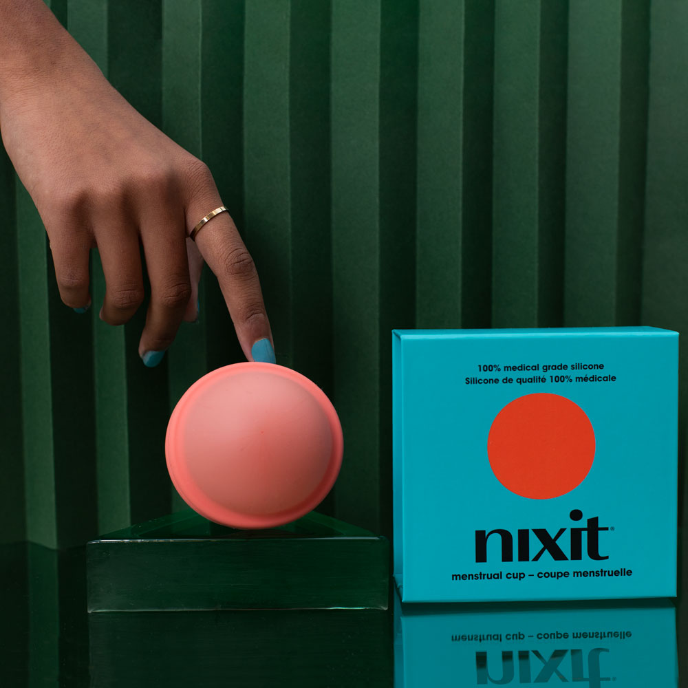 nixit one size menstrual disc with hand and teal box
