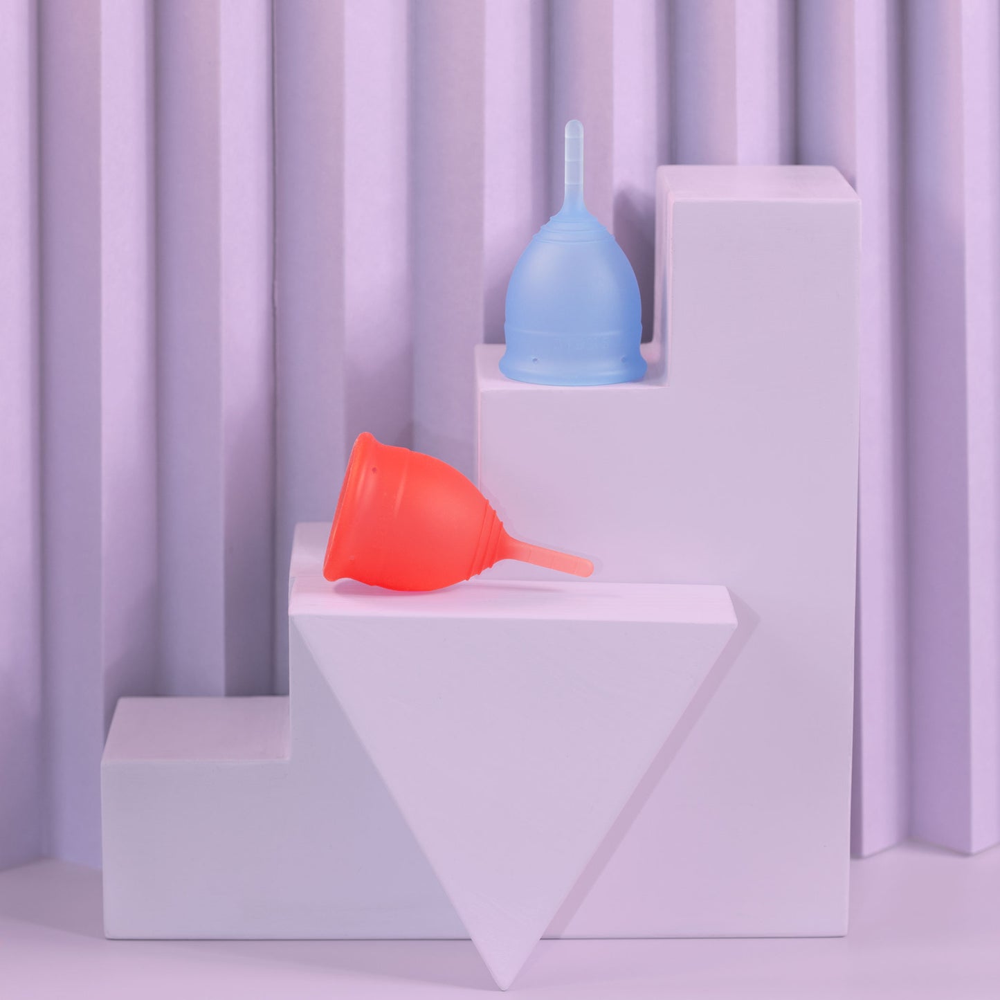 Saalt menstrual cups in size smalls blue and pink on steps